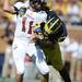 UMass quarterback Mike Wegzyn is tackled by defensive end Frank Clark in the first quarter against UMass at Michigan Stadium on Saturday. Melanie Maxwell I AnnArbor.com